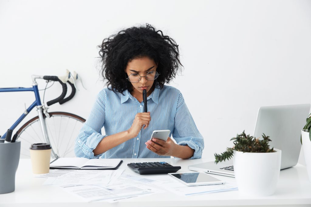 frustrated young female entrepreneur in formal shirt and eyewear having a problem